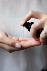 Oway Curly Potion curl-defining lotion dispensed from the pump into the palm