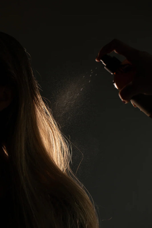 Oway Bodifying Hair Renewer 160ml being sprayed through long hair