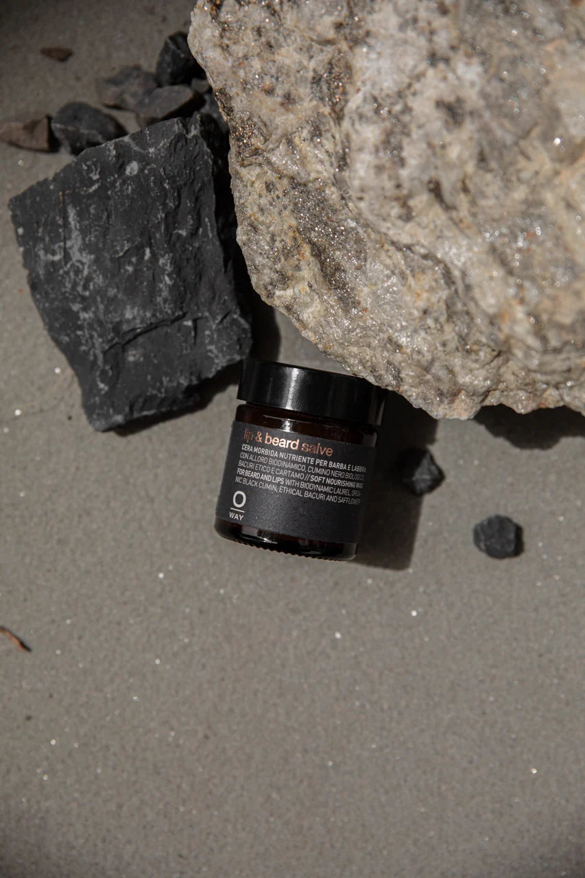 Oway Lip & Beard Salve jar styled among mineral rocks