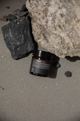 Oway Lip & Beard Salve jar styled among mineral rocks