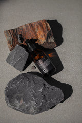Oway Nocturnal Hair Remedy 100ml bottle styled with volcanic rock
