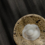 White Oway Repairing Aftershave Balm on a porous beige stone