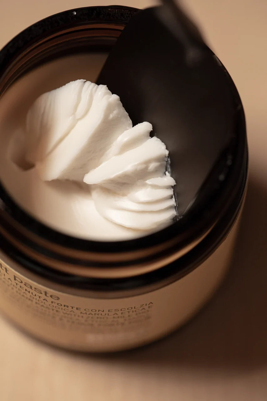 Close-up of the creamy styling paste inside an open Oway Supreme Matt Paste 50ml jar
