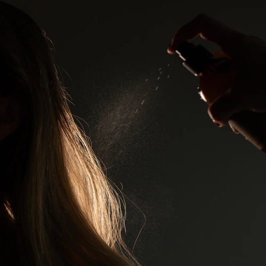 Oway Sculpting Mist being sprayed onto long hair to set the finished style
