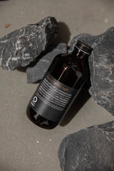Oway Silver Steel Hair Bath bottle styled with volcanic rock