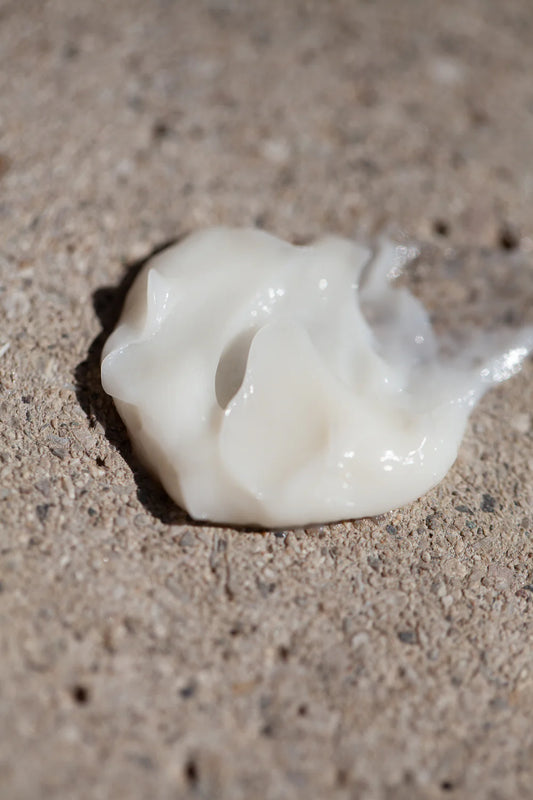 White Oway Softening shave cream on a textured stone surface