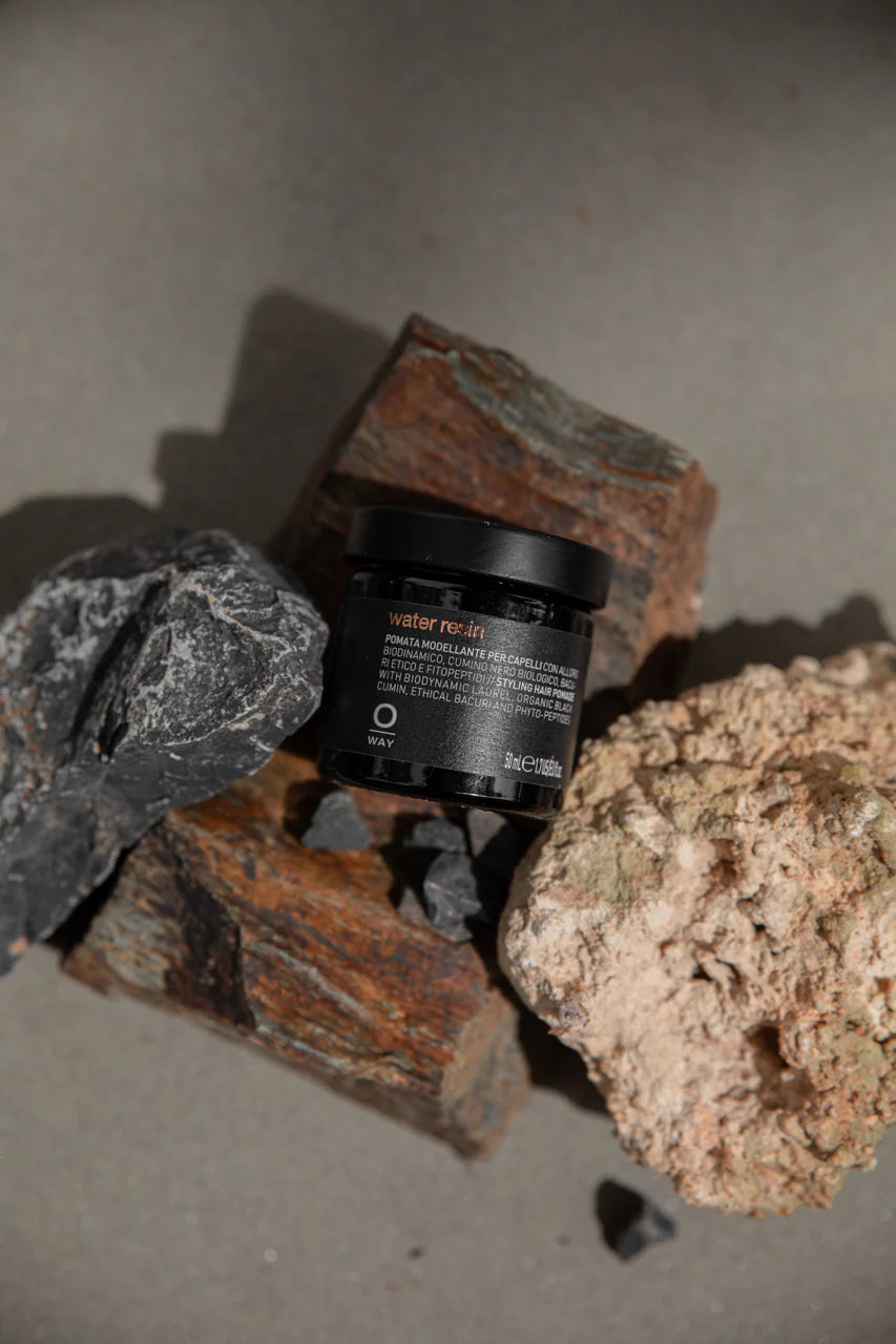 Oway Water Resin hair pomade jar styled with volcanic rock
