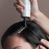 Oway Hydro-Balance Scalp Gel applied directly to the dry scalp using the applicator nozzle