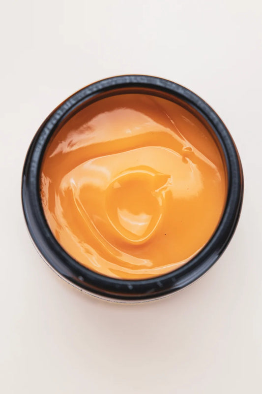Close-up of the golden-orange texture of Oway Blondeway Sunset Hour Hair Mask
